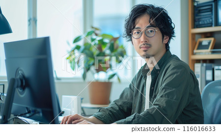 Asian man working on a desktop 01 Asian man working on a desktop 01 116016633