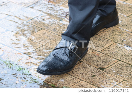 Puddle and businessman's shoes 116017541