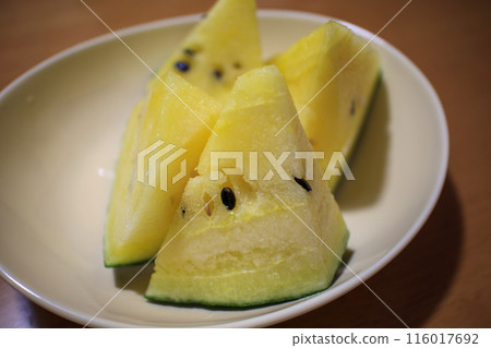 Sliced yellow watermelon served on a plate (horizontal composition) Sliced yellow watermelon served on a plate (horizontal composition) 116017692