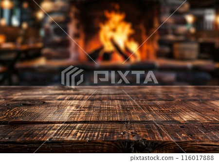 Table background with blurred fireplace. Board template with house interior and fire. Empty rustic wooden desk. Christmas holiday with copyspace Table background with blurred fireplace. Board template with house interior and fire. Empty rustic wooden desk. Christmas holiday with copyspace 116017888