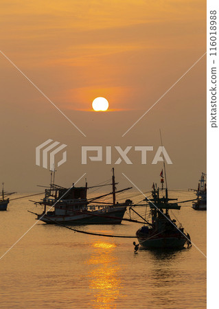 Fishing Wood boat on peaceful calm relaxing on the water and dramatic clouds at Sunset Fishing Wood boat on peaceful calm relaxing on the water and dramatic clouds at Sunset 116018988