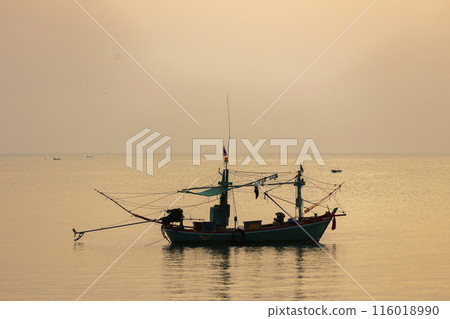 Fishing Wood boat on peaceful calm relaxing on the water and dramatic clouds at Sunset Fishing Wood boat on peaceful calm relaxing on the water and dramatic clouds at Sunset 116018990