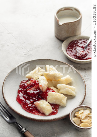 Lazy dumplings, vareniki with raspberry jam on white background. Boiled cottage cheese homemade gnocchi, text space Lazy dumplings, vareniki with raspberry jam on white background. Boiled cottage cheese homemade gnocchi, text space 116019188