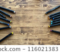 Background. Wooden table with scattered markers 116021383