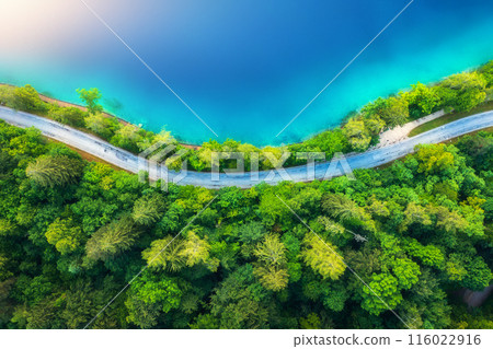 Aerial view of road near blue lake, forest at sunrise in summer 116022916