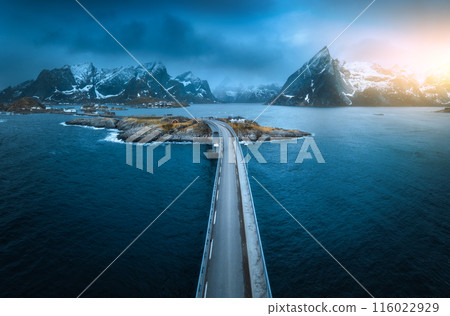 Aerial view of bridge, island, sea, snowy mountains in fog 116022929