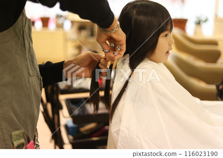 Girl getting her hair cut at a beauty salon Hair donation image 116023190
