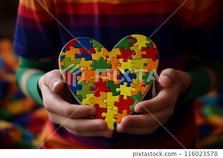 World autism awareness day concept. Childs hands holding puzzle heart with copy space 116023578