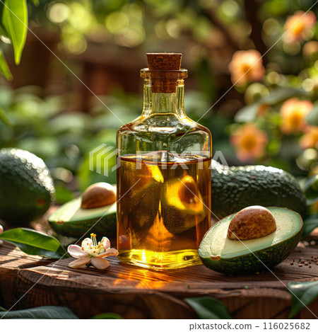 Bottle avocado oil surrounded avocados, rustic wooden background. Sun setting background 116025682