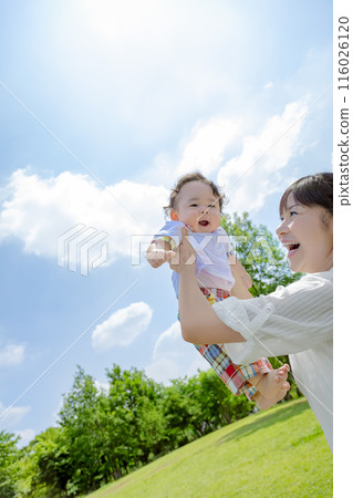 母親在公園裡高高地抱著她的孩子 116026120