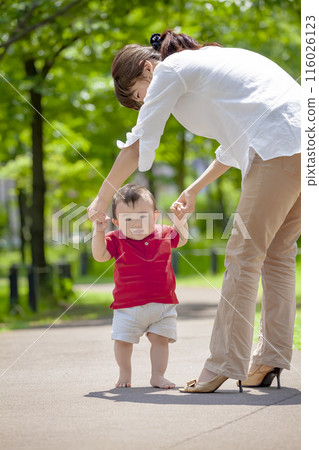 Mother with toddler playing in the park 116026123