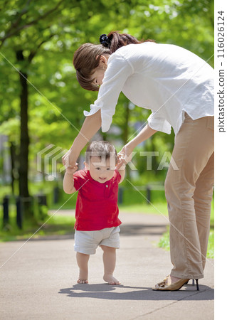 Mother with toddler playing in the park 116026124