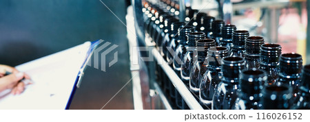 Bottles filling automation machine in modern factory. Technology demonstration of filling and capping bottles in the industry. Inspection of Vials For Defects. Pharmaceutical and drink Manufacturing. Bottles filling automation machine in modern factory. Technology demonstration of filling and capping bottles in the industry. Inspection of Vials For Defects. Pharmaceutical and drink Manufacturing. 116026152