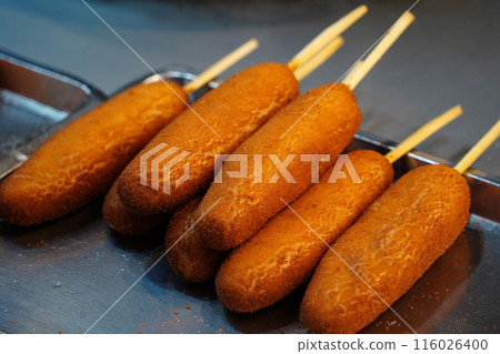 Corndogs are hotdogs made from cornmeal batter fried in hot cooking oil Corndogs are hotdogs made from cornmeal batter fried in hot cooking oil 116026400