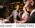 Woman shows gesture stop to man talking at table in pub 116027492