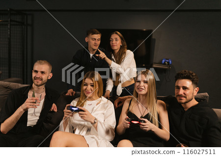 Joyful people enjoy pastime in modern gaming club together 116027511