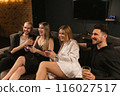 Ladies engaged in friedly competition playing video games 116027517