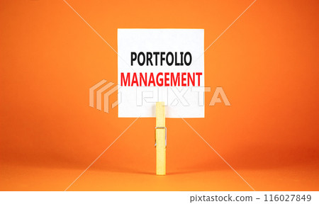 Portfolio management symbol. Concept words Portfolio management on beautiful white paper on wooden clothespin. Beautiful orange background. Business Portfolio management concept. Copy space. 116027849