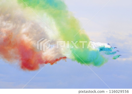 The Frecce Tricolori, Italy's celebrated aerobatic team flying on the blue sky background, 116029556