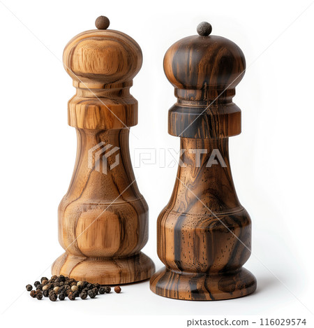 Elegant wooden salt and pepper grinders showcasing different shades of wood, accompanied by a mix of peppercorns isolated on the white background. Suitable for culinary magazines and kitchenware Elegant wooden salt and pepper grinders showcasing different shades of wood, accompanied by a mix of peppercorns isolated on the white background. Suitable for culinary magazines and kitchenware 116029574