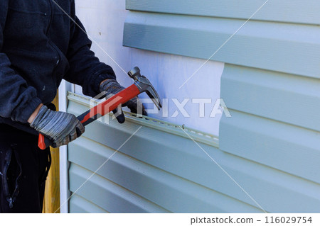 When reconstructing exterior of house, damaged plastic siding is replaced When reconstructing exterior of house, damaged plastic siding is replaced 116029754