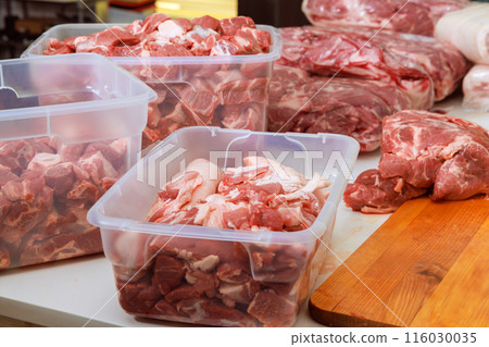 It is prepared for cooking over BBQ grill by marinating raw pork meat 116030035