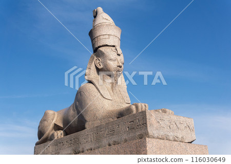 antique statue of the ancient Egyptian sphinx against the sky 116030649