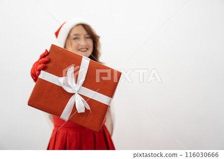 Moment of surprise and joy a woman reveals a secret, showing a wonderful gift for her beloved people. The smell of the holiday - a red gift box hugs the hands of a woman who is ready to please her Moment of surprise and joy a woman reveals a secret, showing a wonderful gift for her beloved people. The smell of the holiday - a red gift box hugs the hands of a woman who is ready to please her 116030666