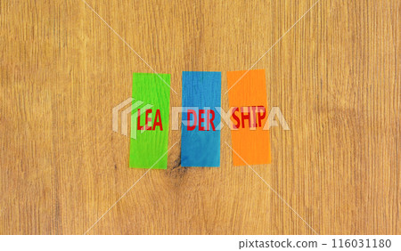 Leadership symbol. Concept word Leadership on beautiful colored paper. Beautiful wooden background. Business leadership concept. Copy space. 116031180