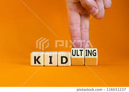 Kid or kidulting symbol. Concept words Kid or Kidulting on wooden cubes. Beautiful orange table orange background. Psychologist hand. Healthy lifestyle and kid or kidulting concept. Copy space. Kid or kidulting symbol. Concept words Kid or Kidulting on wooden cubes. Beautiful orange table orange background. Psychologist hand. Healthy lifestyle and kid or kidulting concept. Copy space. 116031237