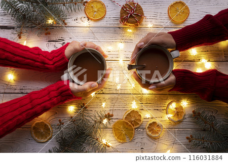 Close up hands holding mugs 116031884