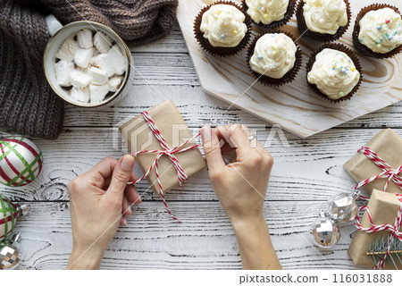 close up hands packing gift 116031888