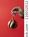 close up hand holding christmas globe 116032012