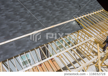 Timber wooden truss frame beam house stick built home under framework construction new build Timber wooden truss frame beam house stick built home under framework construction new build 116032728