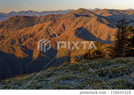 Mt. Kurogane and the Southern Alps at sunrise as seen from Mt. Koreyama in Okuchichibu 116033328