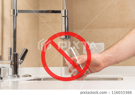 Hand fills a glass with water from the tap, accompanied by a red prohibition symbol, warning of undrinkable, polluted water Hand fills a glass with water from the tap, accompanied by a red prohibition symbol, warning of undrinkable, polluted water 116033366