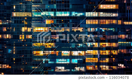 A lit skyscraper stands against the night sky, windows glowing in patterns, reflecting urban vibrance. 116034078
