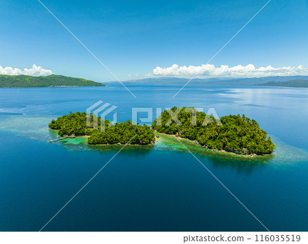 Islands with beach resort in tropical landscape. Bangkay Island. Mindanao, Philippines. Summer and travel concept. Islands with beach resort in tropical landscape. Bangkay Island. Mindanao, Philippines. Summer and travel concept. 116035519