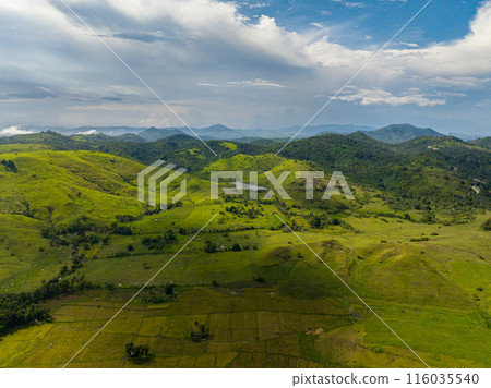 Tropical mountain with farmland over the blue sky and clouds. Mindanao, Philippines. 116035540