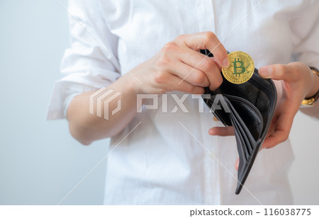Cropped shot of woman collecting golden Bitcoin token in leather wallet. Bitcoin is one of the popular cryptocurrency, a virtual currency or a digital currency. Cropped shot of woman collecting golden Bitcoin token in leather wallet. Bitcoin is one of the popular cryptocurrency, a virtual currency or a digital currency. 116038775