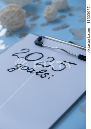 2025 GOALS New year's resolutions on paper note with Christmas decor. Making promises for new year, setting goals. Creating dream vision board 2025 GOALS New year's resolutions on paper note with Christmas decor. Making promises for new year, setting goals. Creating dream vision board 116039774