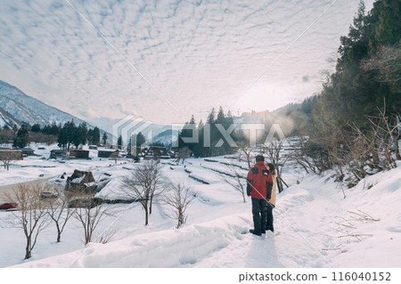 Couple taking photos of snowy mountains in winter Couple taking photos of snowy mountains in winter 116040152