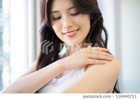 Young woman with long black hair (beauty image, skin care, white sleeveless, window sill, natural light) 116040721