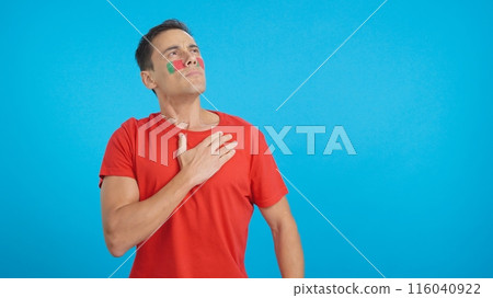 Man listening to the Portugal national anthem with solemnity 116040922