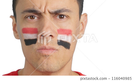 Serious man with a egyptian flag painted on the face 116040985