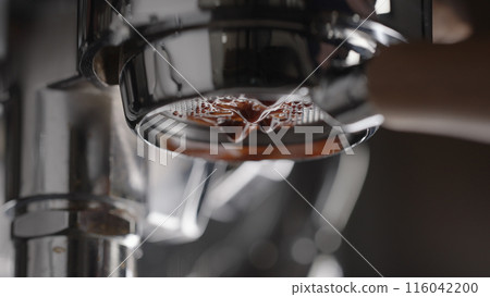pull espresso shot with bottomless portafilter on a professional coffee machine 116042200