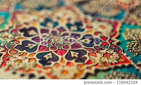 A close-up of a rare, ornate stamp displays its vivid colors and intricate details, a prized collectors item. A close-up of a rare, ornate stamp displays its vivid colors and intricate details, a prized collectors item. 116042584