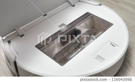 A vacuum cleaner's dust compartment filled with hair and dust, indicating it needs to be emptied. 116043098