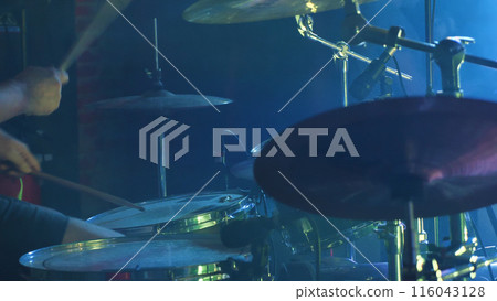 A detailed view of a drum set, including high-hats, snare drums, tom-toms, and cymbals, each contributing to the unique sound and rhythm of music. A detailed view of a drum set, including high-hats, snare drums, tom-toms, and cymbals, each contributing to the unique sound and rhythm of music. 116043128
