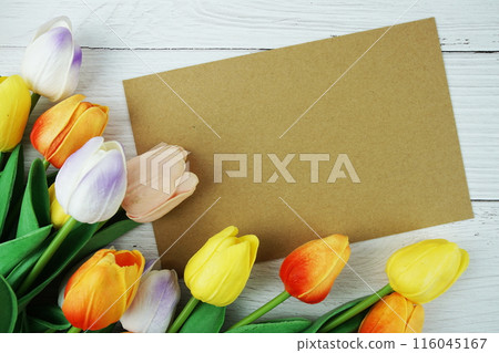 Greeting card mockup space for text message decorations with flowers top view on wooden background Greeting card mockup space for text message decorations with flowers top view on wooden background 116045167